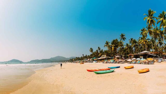 beautiful picturesque goan beach with sand sea and trees