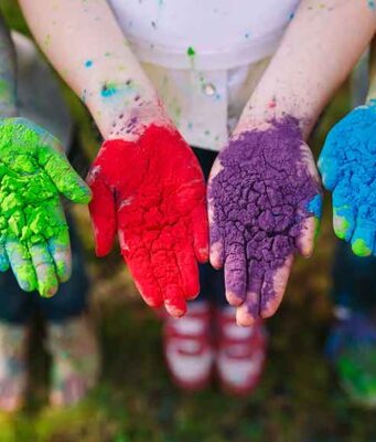 5 Fascinating Indian Festivals: A Guide to India’s Colorful Celebrations kids hands with holi powder colors