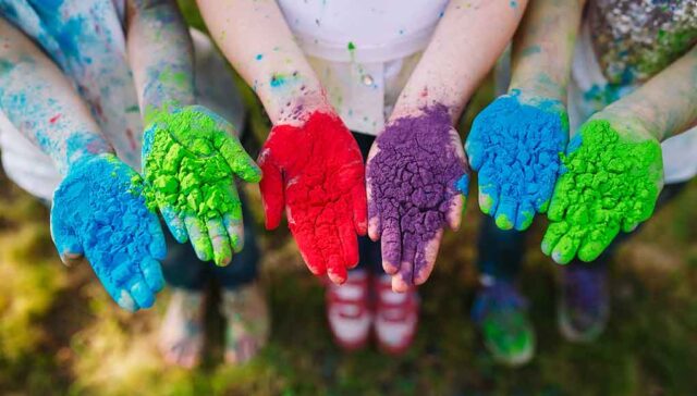 kids hands with holi powder colors