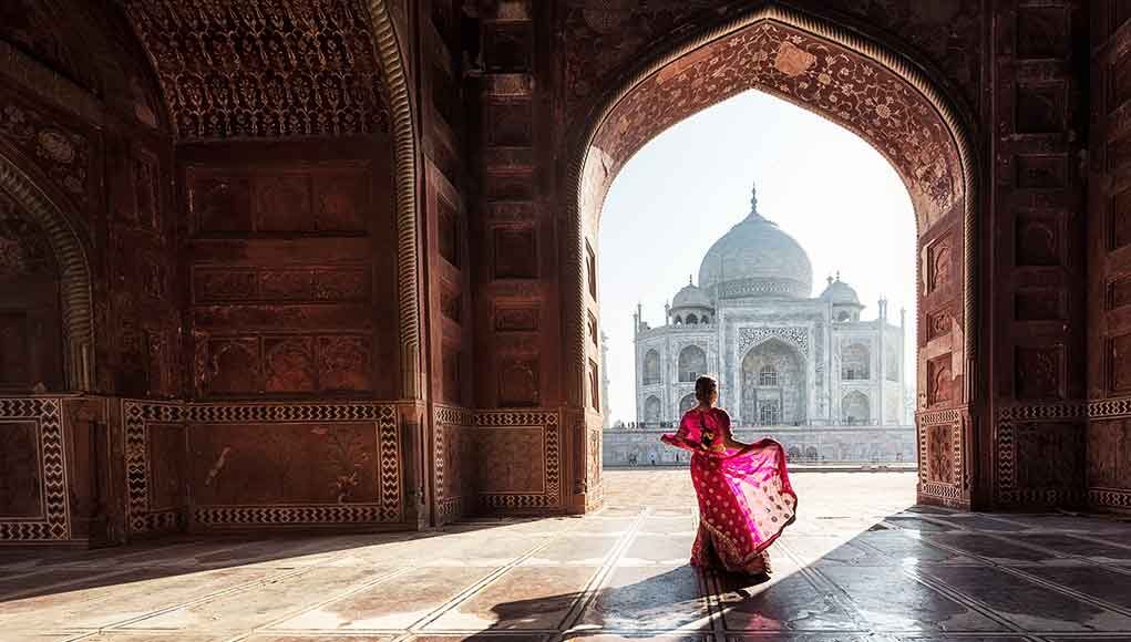 5 Must-Visit Monuments to See: Explore India’s Iconic Landmarks lady in pink dress dancing in front of taj mahal