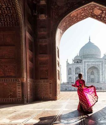 5 Must-Visit Monuments to See: Explore India’s Iconic Landmarks lady in pink dress dancing in front of taj mahal